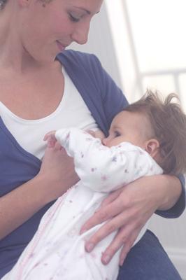Me feeding Esmé in my Rooti Tooti vest and wrap